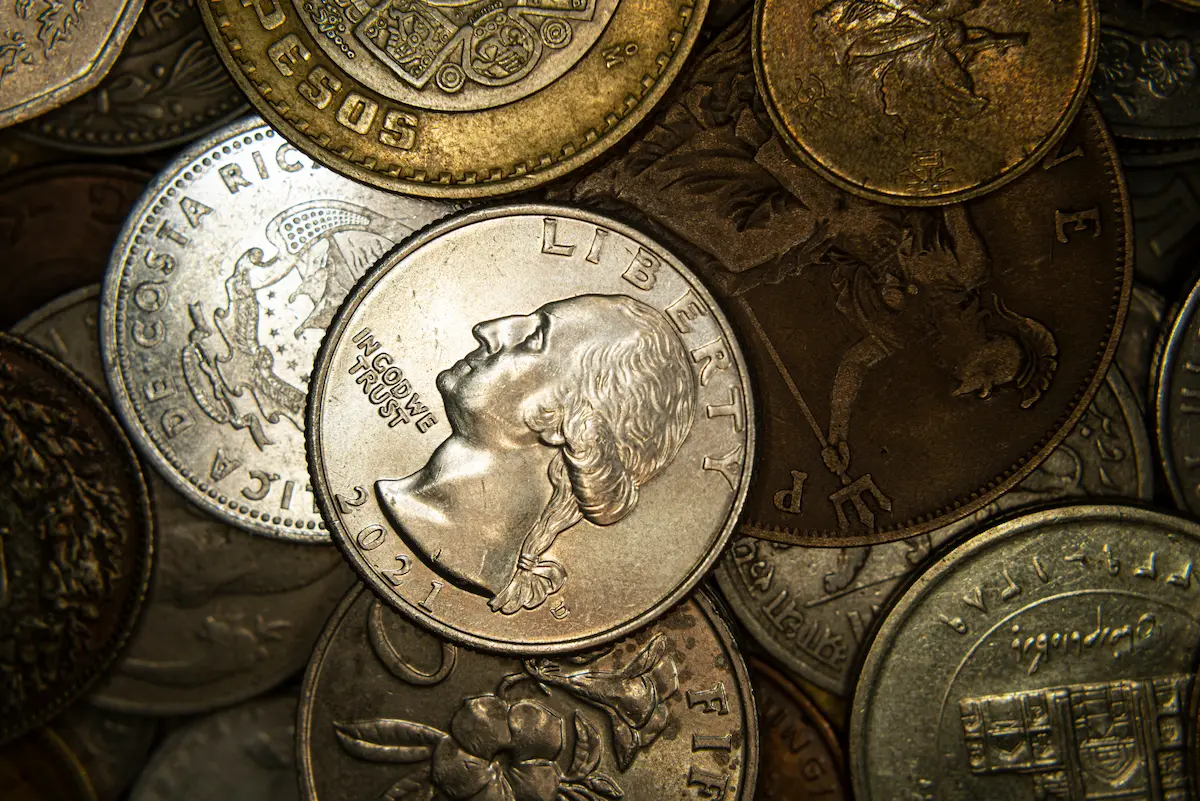 a-heap-of-world-coins-closeup-grunge-financial-ba-2025-02-10-07-54-27-utc.webp